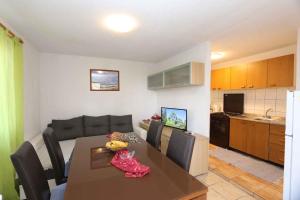 a living room with a dining room table and a kitchen at Apartment in Silo/Insel Krk 13555 in Šilo