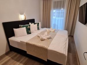 Postel nebo postele na pokoji v ubytování Alexandra Apartman