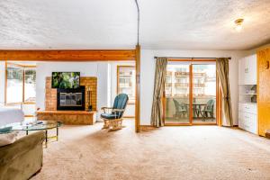 a living room with a couch and a table at Timberline Getaway in Girdwood