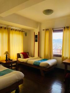 a hotel room with two beds and a window at Kathmandu View Hotel in Kathmandu