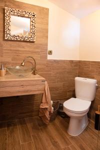 a bathroom with a toilet and a sink at Forest Lux Boutique Villas in Rakitovo
