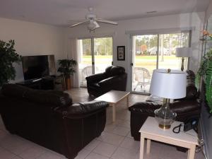 a living room with couches and a table with a lamp at Close to Beach Brunswick Plantation Condo 2302M with 27 Hole Golf Course Onsite condo in Calabash