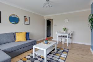 a living room with a couch and a table at Modern 1BR Gem - Stylish Flat in Harlow in Great Parndon