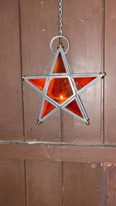 a red and white star hanging from a chain at Gipfelsieg am Hallstättersee in Bad Goisern