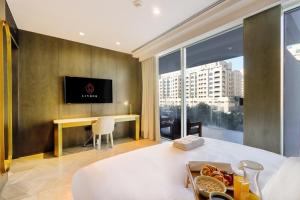 a hotel room with a table with a tray of food at Five Palm - Residential 2 BR Suite with Private Beach -Livbnb in Dubai