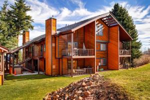 a large wooden house with a yard at Big Views at Red Pine in Park City
