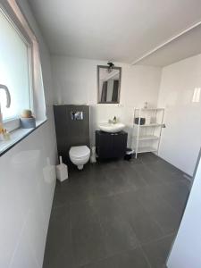 uma casa de banho branca com um WC e um lavatório em Fühl dich Willkommen - Messe, Projekte, em Hanau am Main