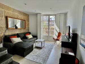 a living room with a couch and a table at Casa Cousiño Zona Monumental in Pontevedra