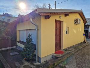 a small house with a tree in front of it at Warm house full of green ambient,joy and comfort in Zagreb