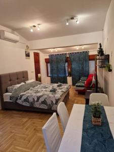 a bedroom with a bed and a table and chairs at Warm house full of green ambient,joy and comfort in Zagreb