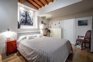 a bedroom with a white bed and a refrigerator at YiD luxury & Design penthouse L5 in Florence