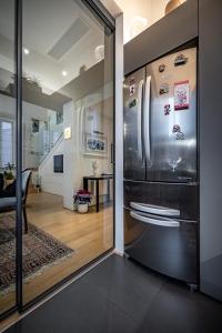 a kitchen with a stainless steel refrigerator and a dining room at YiD luxury & Design penthouse L5 in Florence