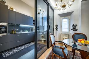 a kitchen with a table and a dining room at YiD luxury & Design penthouse L5 in Florence