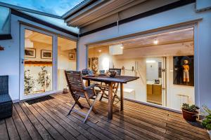 a patio with a table and chairs on a deck at YiD luxury & Design penthouse L5 in Florence