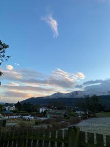 a view of a lake and mountains with a fence at The Courtyard in Newcastle +4 photos