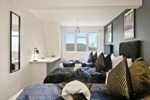 a bedroom with two beds with zebra pillows at Stylish Abode with Games Room - Sleeps 15 in Brislington