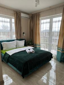 a bedroom with a bed with two towels on it at Villa Speranza Kościelna Droga 12 in Łomianki Dolne