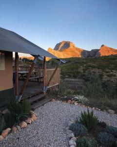 a house with a deck with mountains in the background at Can Elisa Safari Tent in Tárbena