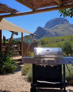 a grill in a yard with a mountain in the background at Can Elisa Safari Tent in Tárbena