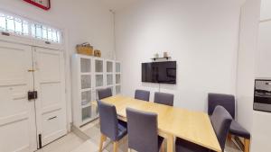 a dining room with a wooden table and chairs at Spacious 3 bedroom maisonette in Sliema