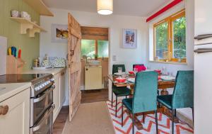 a kitchen with a table and chairs in a kitchen at Finest Retreats - Shrawardine Train Carriage in Shrawardine