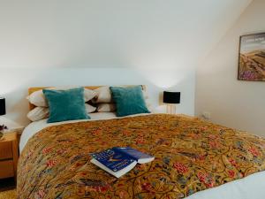 ein Schlafzimmer mit einem Bett, auf dem zwei Bücher liegen in der Unterkunft The Coach House Barn in Shrewsbury