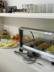 a toaster oven sitting on a counter with food at Pousada Cinnamon in Canela