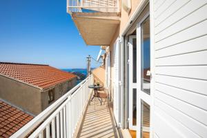 a balcony with a table and a chair on a building at Bellevue Duplex Apartment in Dubrovnik