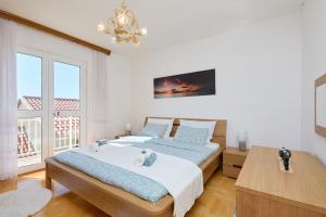a bedroom with a bed and a large window at Bellevue Duplex Apartment in Dubrovnik