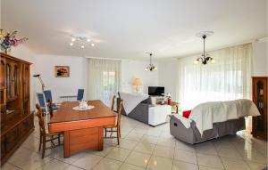 a living room with a table and a couch at 2 Bedroom Stunning Home In Flachères in Flachères
