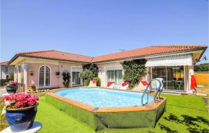 a swimming pool in the yard of a house at Beautiful Home In Flachres With Kitchen in Flachères