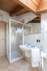 a bathroom with a sink and a shower at La Filanda Apartments by Wonderful Italy - Canapa in Bellagio