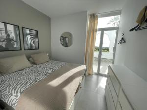 a bedroom with a zebra print bed and a window at Penthouse with stunning views in Benahavís in Benahavís