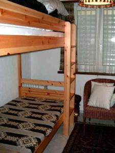 a bedroom with a bunk bed and a chair at Casa Franci in Ascona