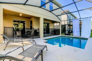 a house with a swimming pool and a patio at Paradise Palms Esate - Paradise Palms Resort in Kissimmee