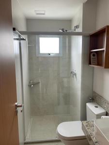 a bathroom with a shower with a toilet and a sink at Salinas Exclusive Resort Salinópolis in Salinópolis