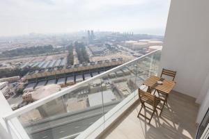 a balcony with a chair and a view of a city at Revelton Apartment Studio One in Dubai