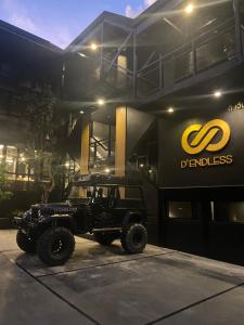 a jeep parked in front of a building at D’Endless Resotel in Baen