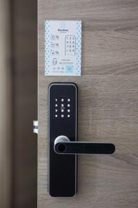 a remote control on a door with a card on it at Revelton Apartment Studio One in Dubai