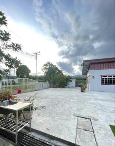 a large yard with a table and a chair at D’Aliff Pamalan Homestay Keningau in Keningau