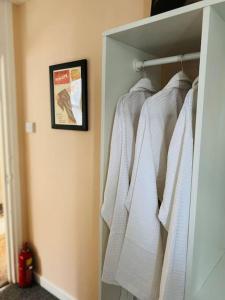 a closet with white towels hanging in a room at 2 Bedroom flat on Tottenham High Rd. in London