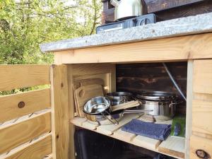 a kitchen with pots and pans inside of a rv at Glamping Point in Byšta