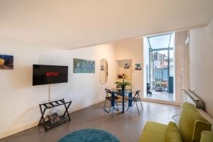 a living room with a couch and a table at [DUOMO WALKING DISTANCE] Central Loft in Milan