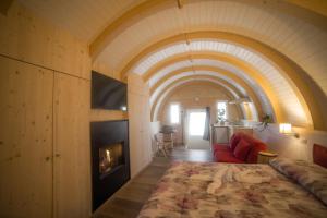 a bedroom with a large bed and a fireplace at Glamping Villaggio Parco Dei Castagni 4 stelle in Montecreto