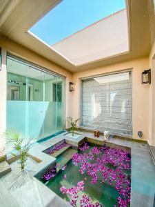 a room with a pond with purple flowers at Brij Bageecha Jaipur - Private Villas with Plunge Pools in Jaipur