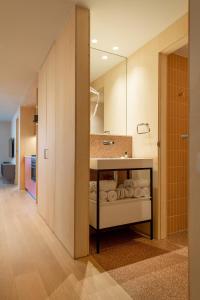 a bathroom with a sink and a mirror at Jardinets De Gràcia by The 5ve Soul in Barcelona