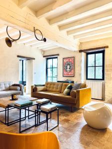 a living room with a couch and a table at LA CLEF DES CHAMPS 61 in La Chapelle-Souëf