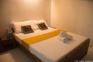 a bedroom with two beds with towels on them at The Calm Cabana in Dambulla