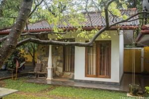 a house with a tree in front of it at The Calm Cabana in Dambulla