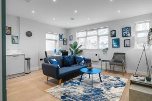 a living room with a couch and a table at Livestay-Luxury Apartments in Southend-on-Sea in Southend-on-Sea